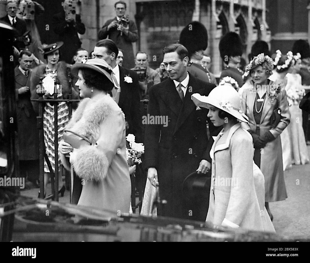 Elizabeth II with Queen Elizabeth (front) and Princess Margaret Rose (hidden) on their way to the wedding of Princess Anne of Denmark, the niece of Queen Elizabeth, and Lord Thomas Anson, 4th Earl of Liechtenstein. Stock Photo
