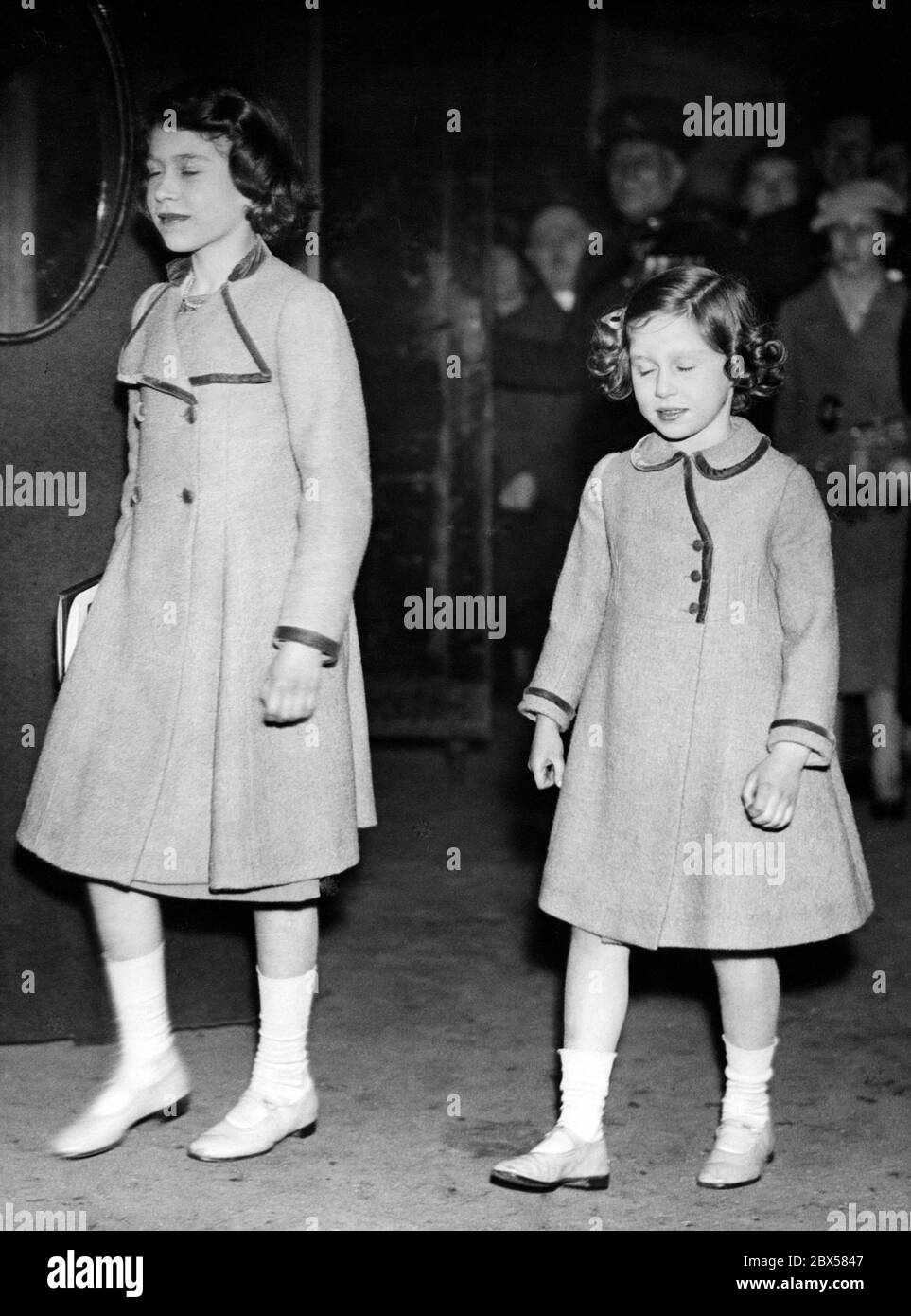 Elizabeth II and her sister Margaret Rose (right) leaving the Royal Box at the National Pony Show held at the Agricultural Hall in Islington, London. Stock Photo