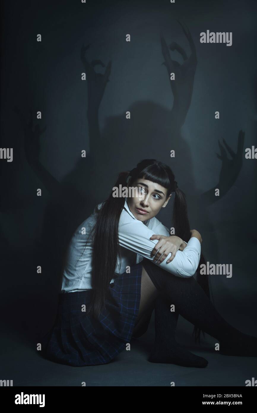 Young woman alone with her fears and demons. Human weakness Stock Photo