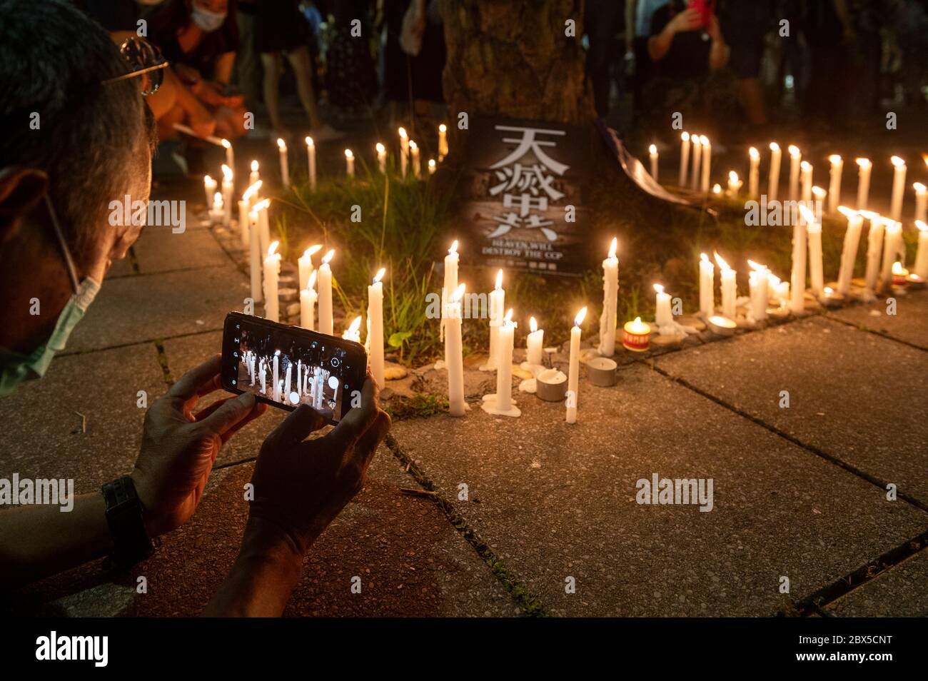 People light candles during the Tiananmen Square vigil remembrance at
