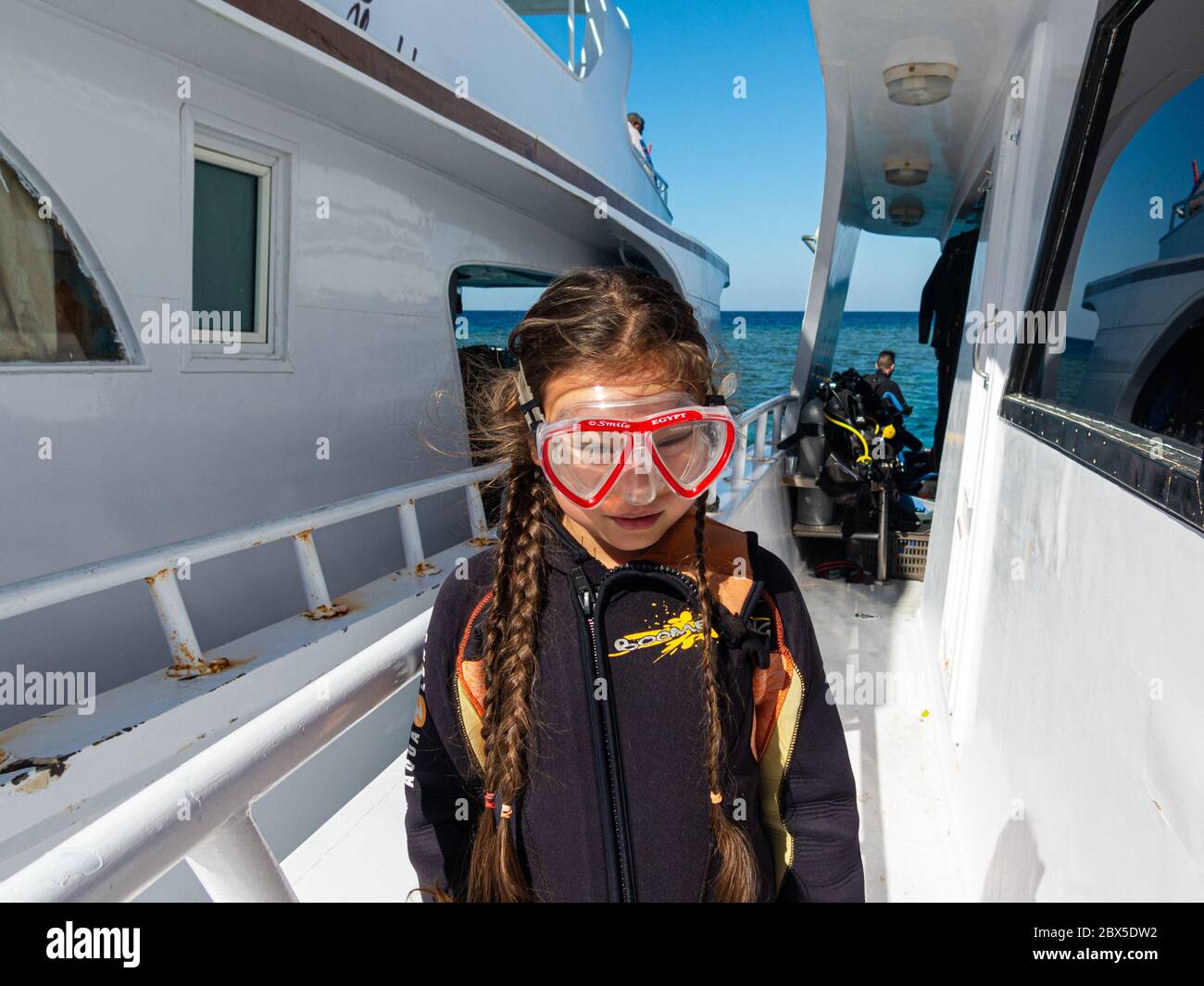 Hurghada, Egypt - January 6, 2017: A eight years old girl with a scuba mask and long brown braids enjoys a day trip on the Red Sea with a dive boat Stock Photo