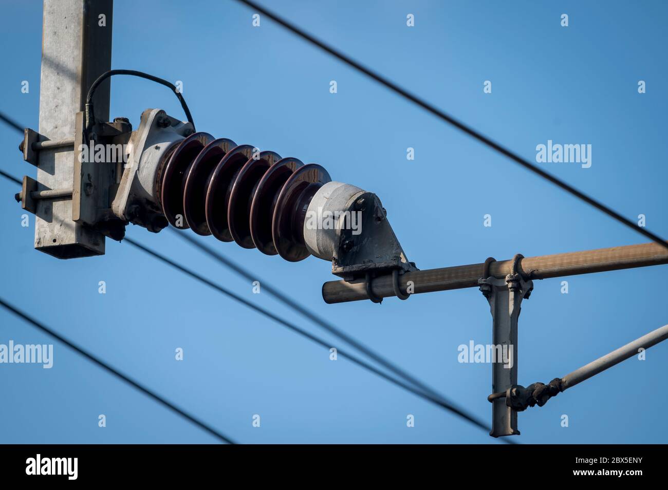 Ceramic insulator and catenary on an electrified railway line in the UK. Stock Photo