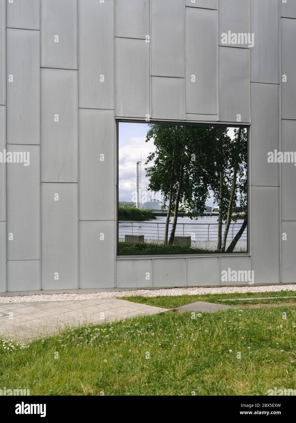 Reflections in the windows of the Riverside Museum, designed by architect Zaha Hadid, situated on the banks of the River Clyde, Glasgow, Scotland. Stock Photo