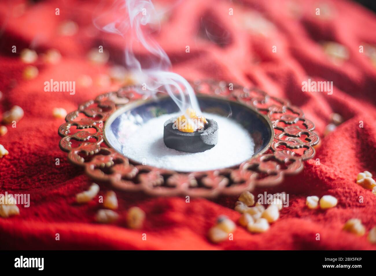 Frankincense burning on a hot coal. aromatic resin, used for religious