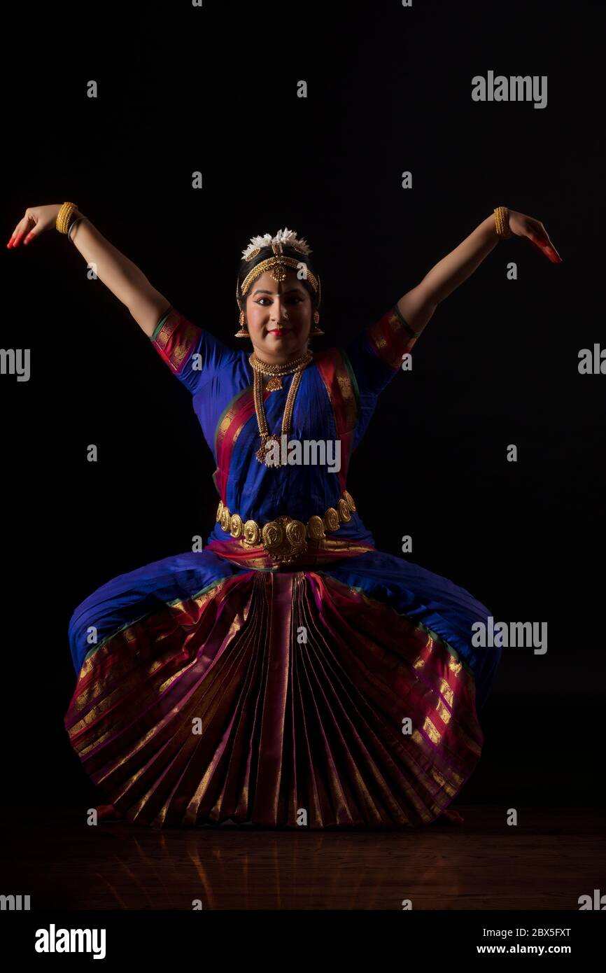 Bharatnatyam dancer in a garuda lingam pose during her performance ...