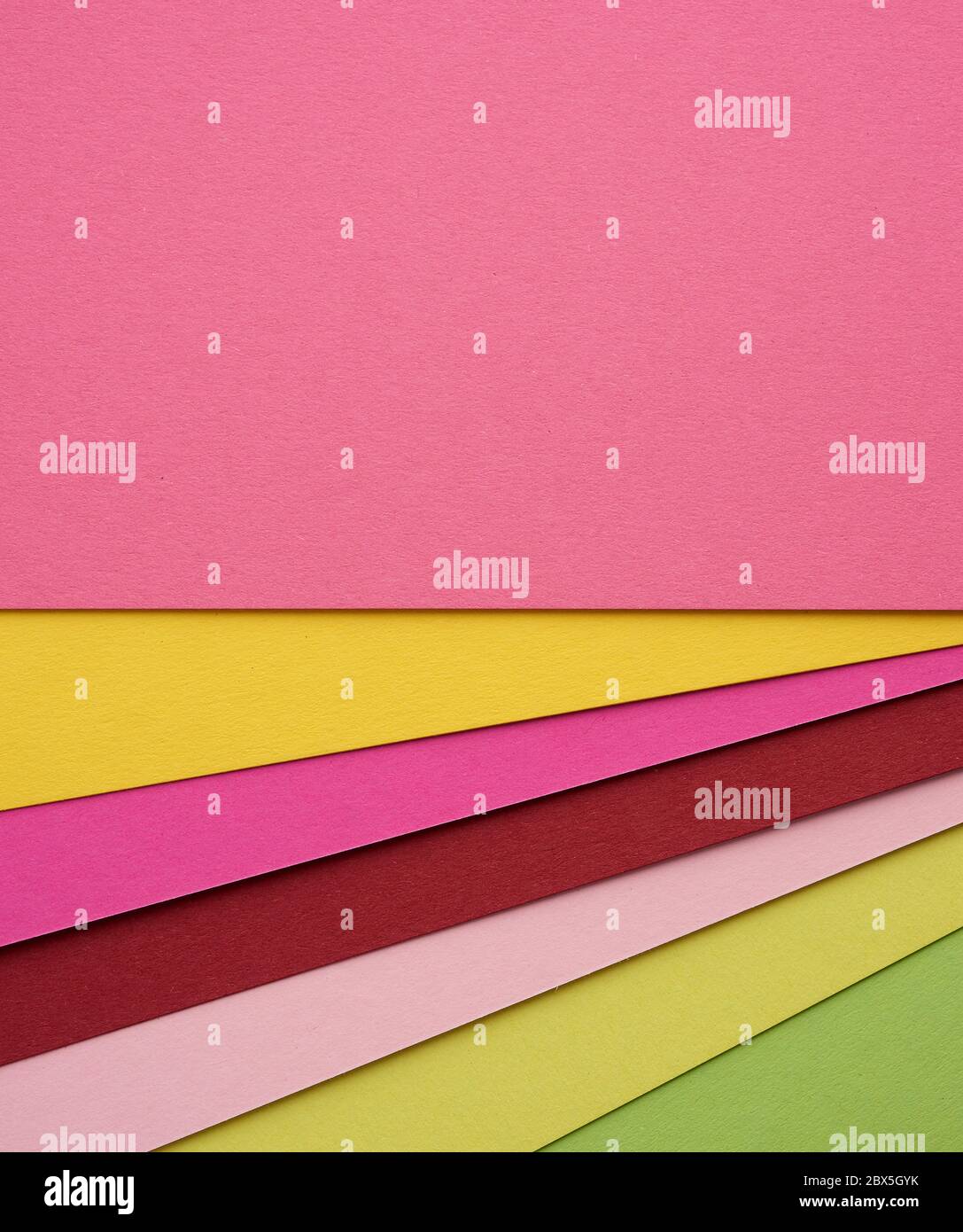 multicolored cardboard folded in layers with a shadow, abstract