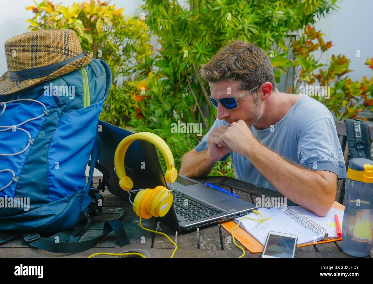 young attractive and happy digital nomad man working outdoors with laptop computer cheerful and confident running business remote in freelancer and in Stock Photo