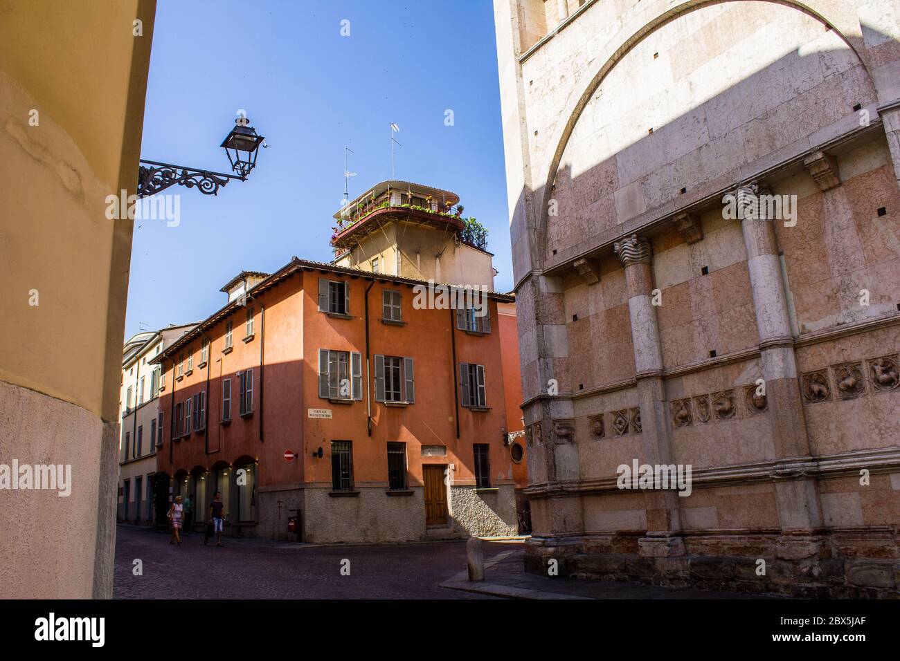 Parma, Italy - July 8, 2017: People Walking near Parma Baptistery in Piazzale del Battistero on a Sunny Day Stock Photo