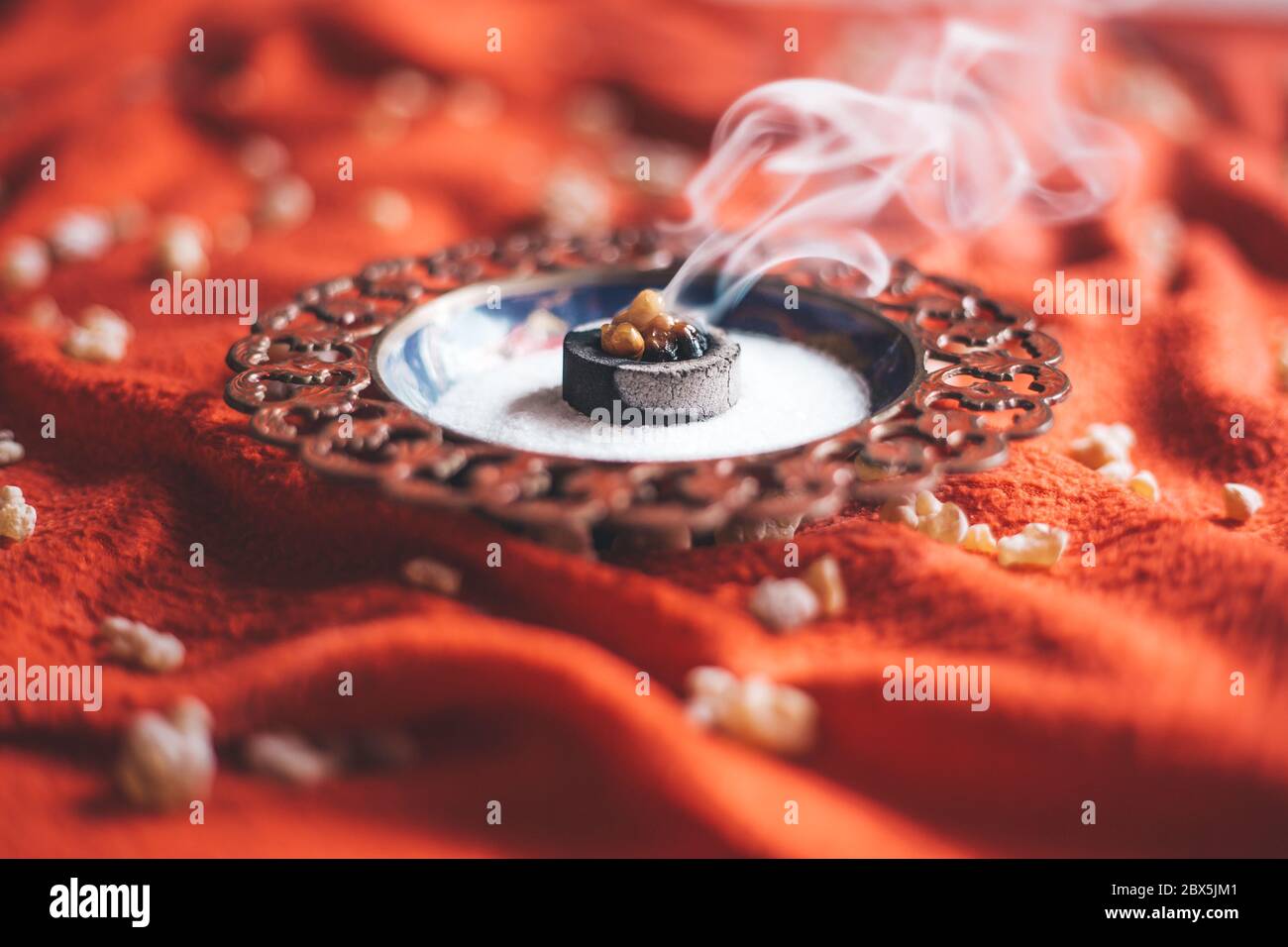 Frankincense burning on a hot coal. aromatic resin, used for religious