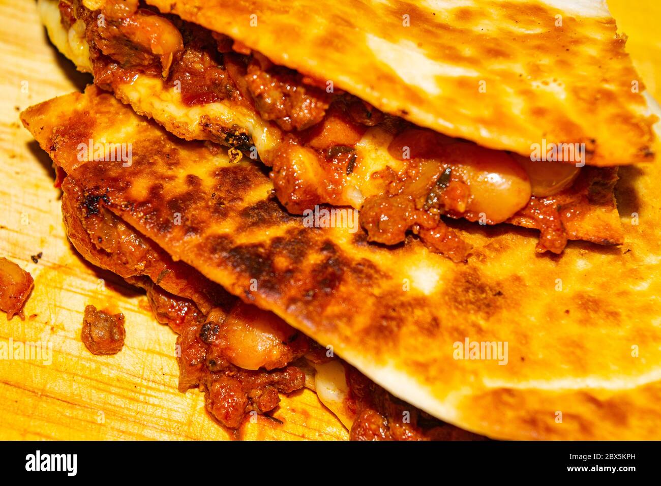 Quesadilla with ground beef, sausage, red beans, sweet corn, onion and