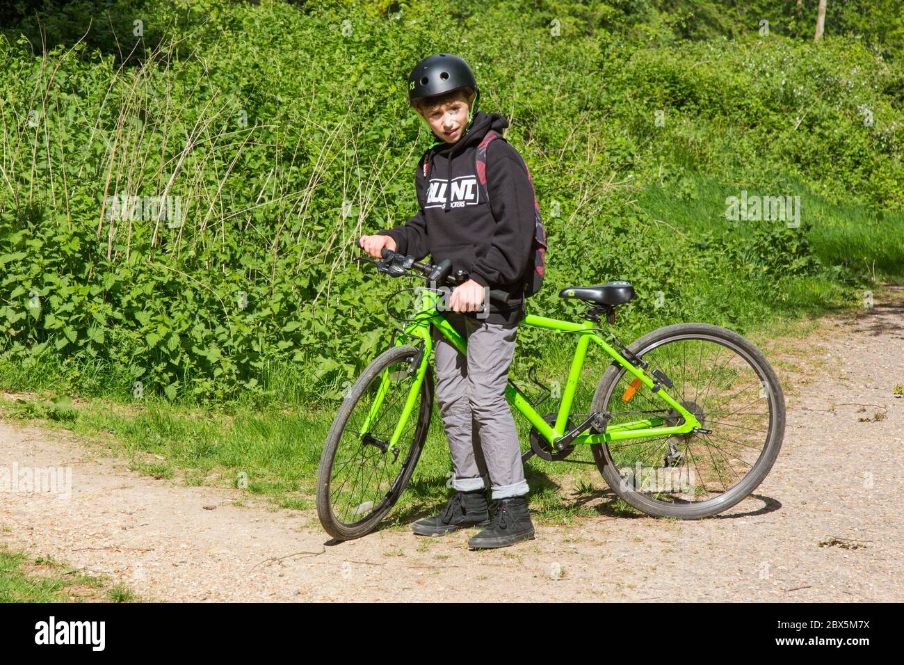 Eleven year old boy on a mountain bike, Chawton park woods,  Medstead, Alton, Hampshire, England, United Kingdom. Stock Photo