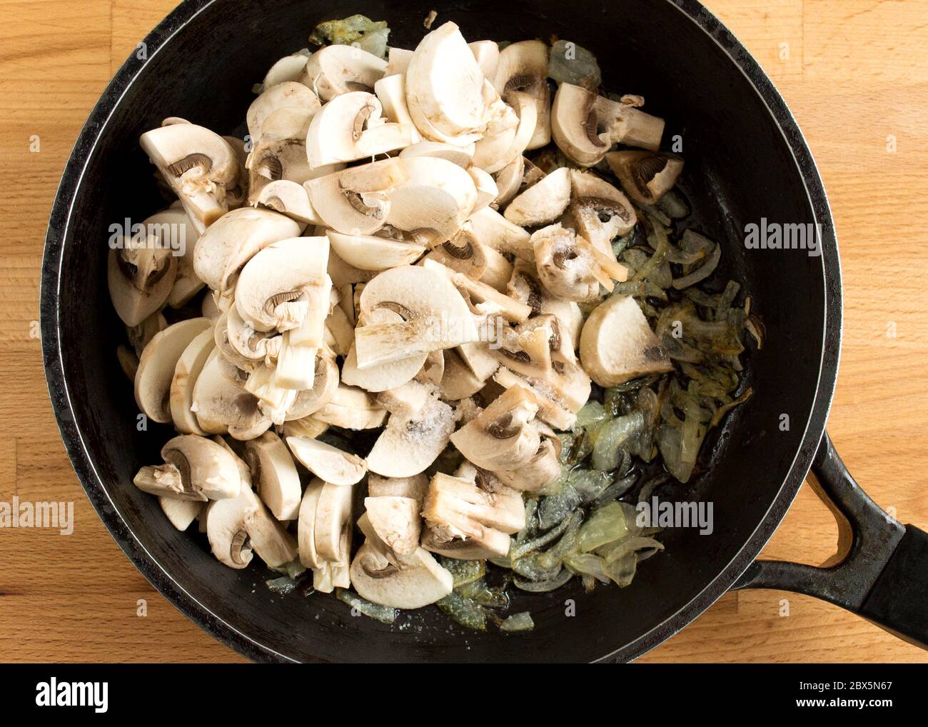 Mushrooms and onions in a pan. Fried mushrooms and vegetables in oil