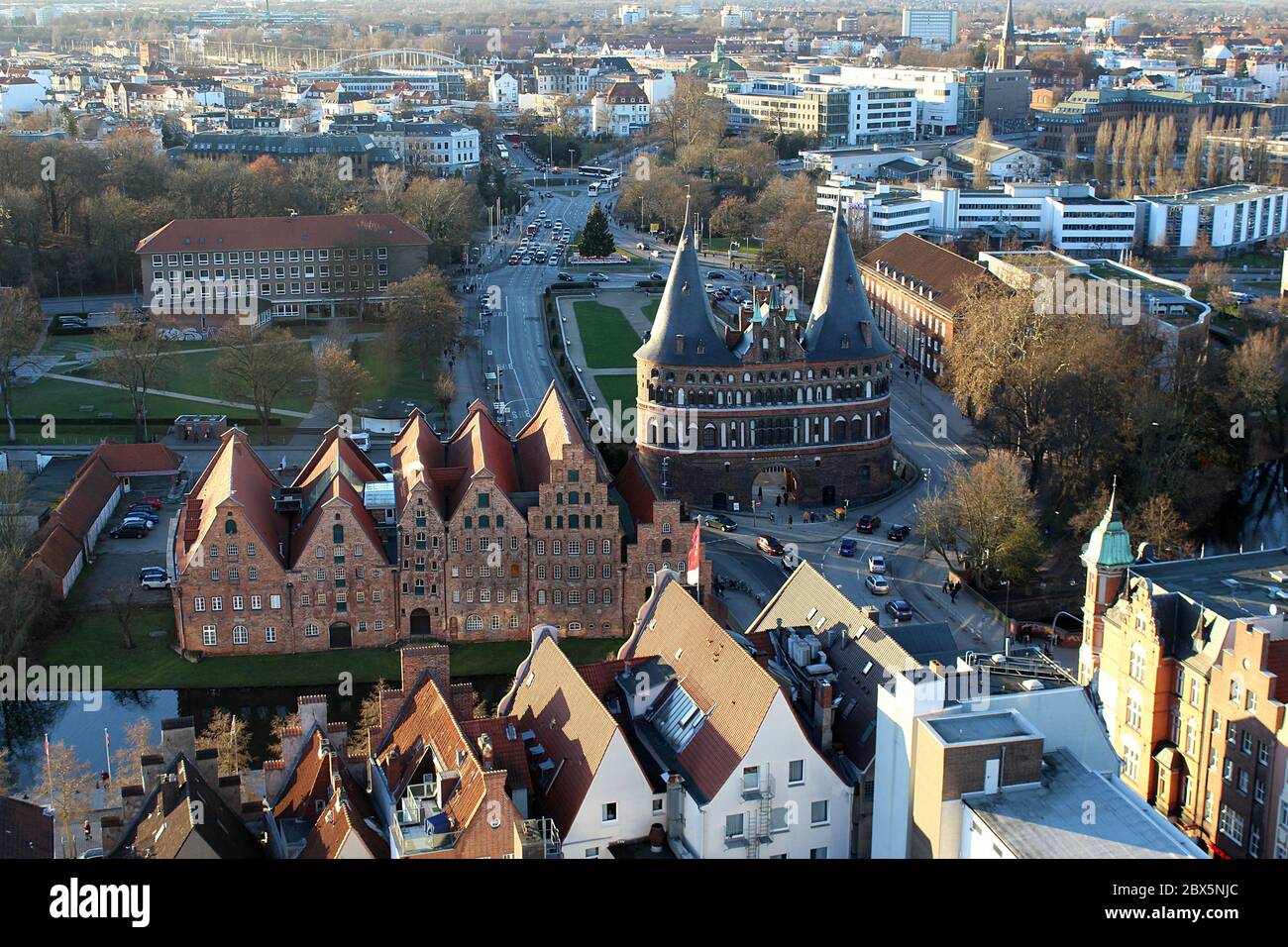Holstentor town gate, the Salzspeicher, and the surrounding streets on a sunny winter evening seen from the Church of St Peter. Famous landmark. Stock Photo