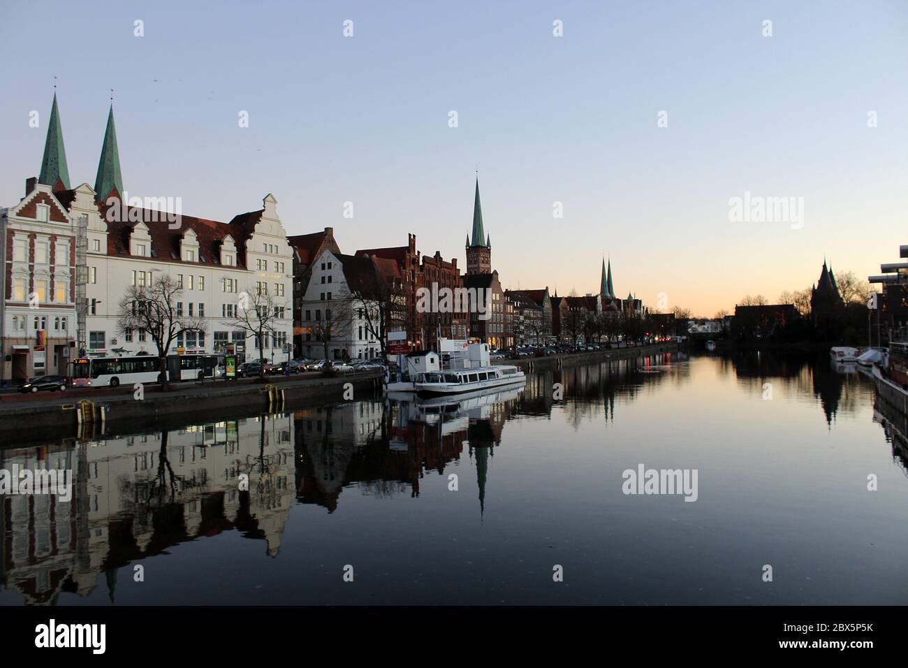 Luebeck, Germany - 2 Dezember 2016: View of Luebeck and the river Trave at dusk. Photo taken from pedestrian brigde at 'An der Untertrave' Stock Photo