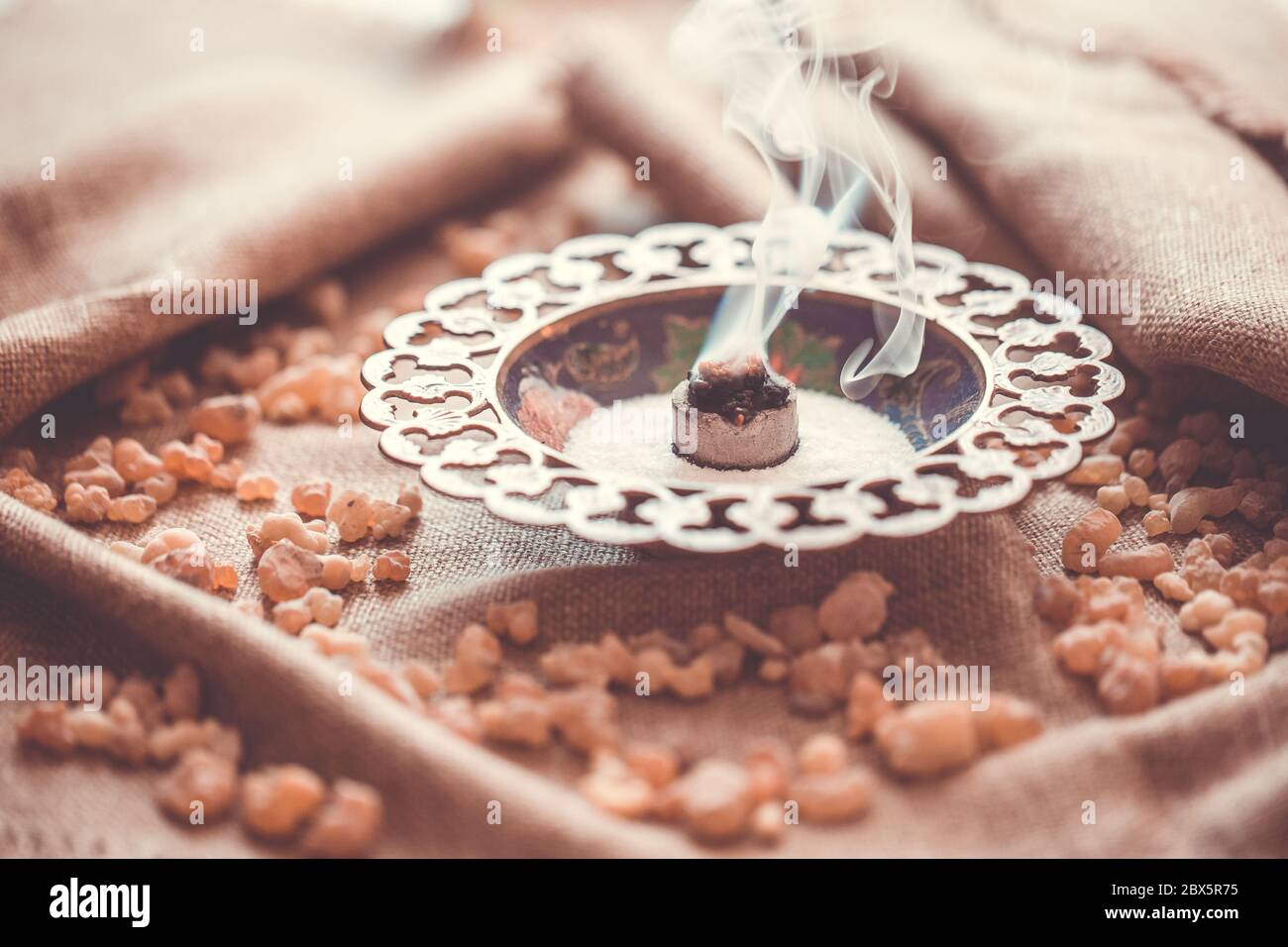 Frankincense burning on a hot coal. Frankincense is aromatic resin