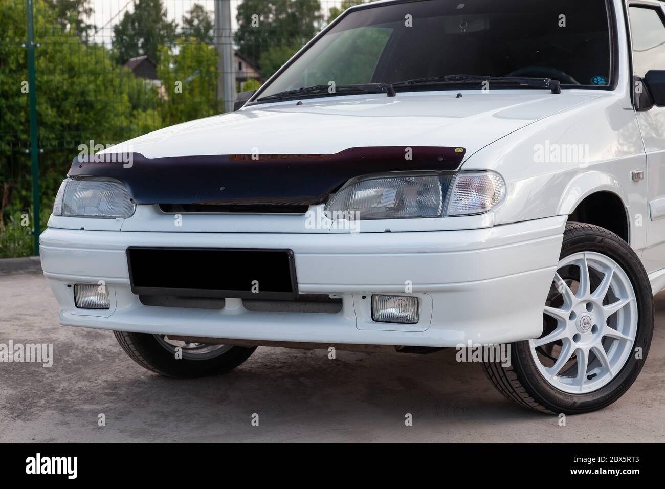 Novosibirsk, Russia - 05.20.2020: The front of the Russian car brand Lada automobile industry VAZ model 2114 of a modern series of white color and clo Stock Photo