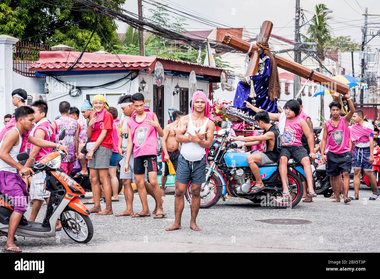 Young Filipino men joke around before heading out on the famous annual Black Nazarene Religious Parade in Manila The Philippines. Stock Photo