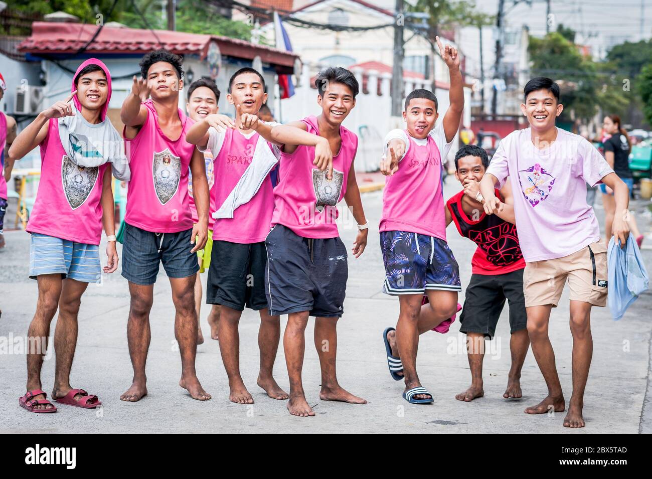 Young Filipino men joke around before heading out on the famous annual Black Nazarene Religious Parade in Manila The Philippines. Stock Photo