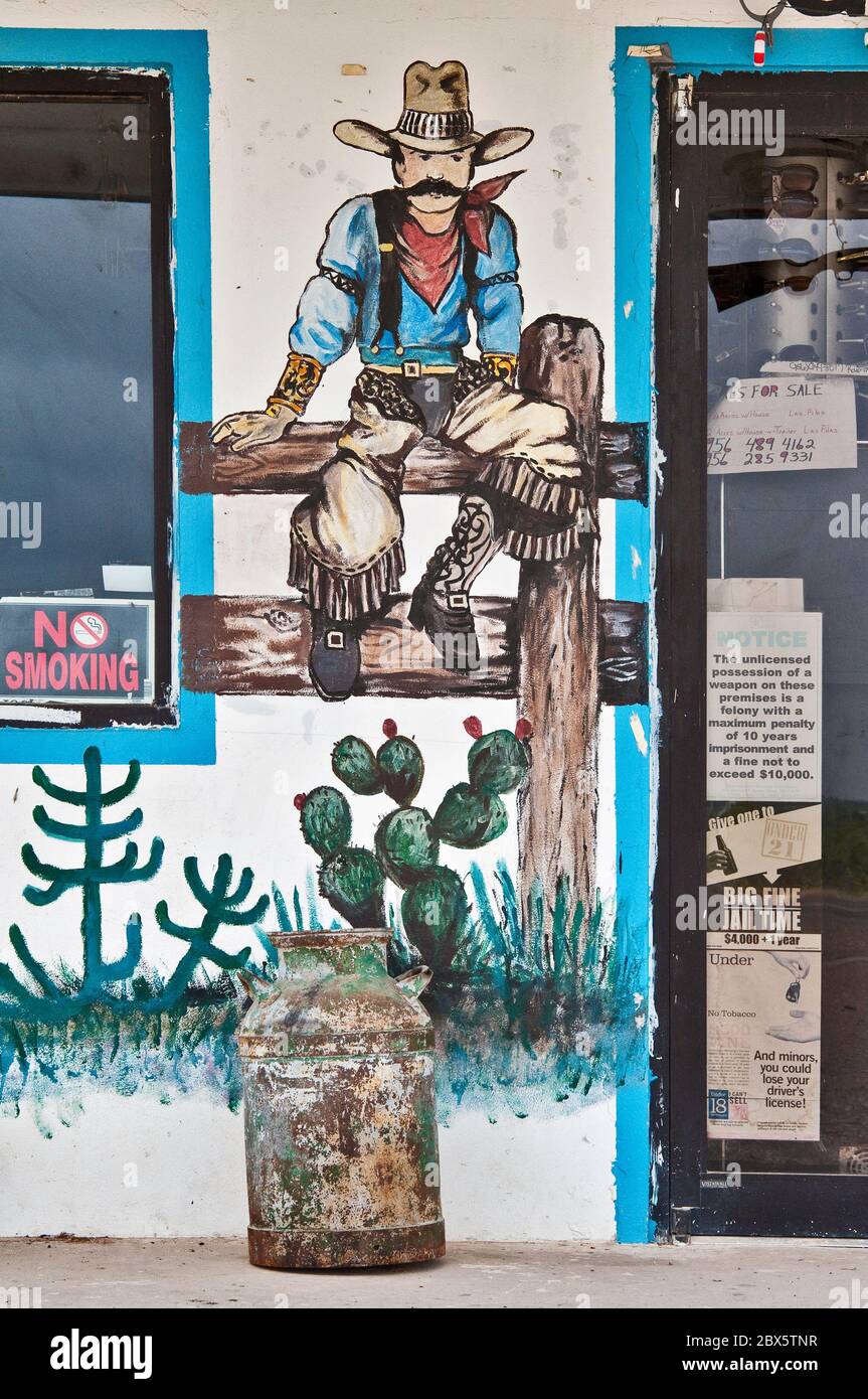 Western art wall paintings at storefront of roadside store and cafe Contreras on highway US-59 near Laredo, Texas, USA Stock Photo