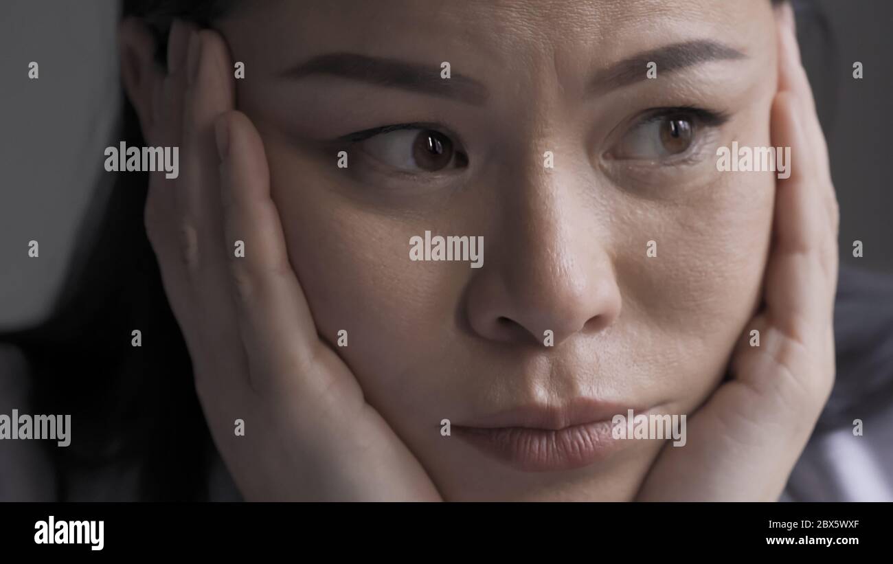 Exhausted female doctor feels stress or headache. Pensive Asian