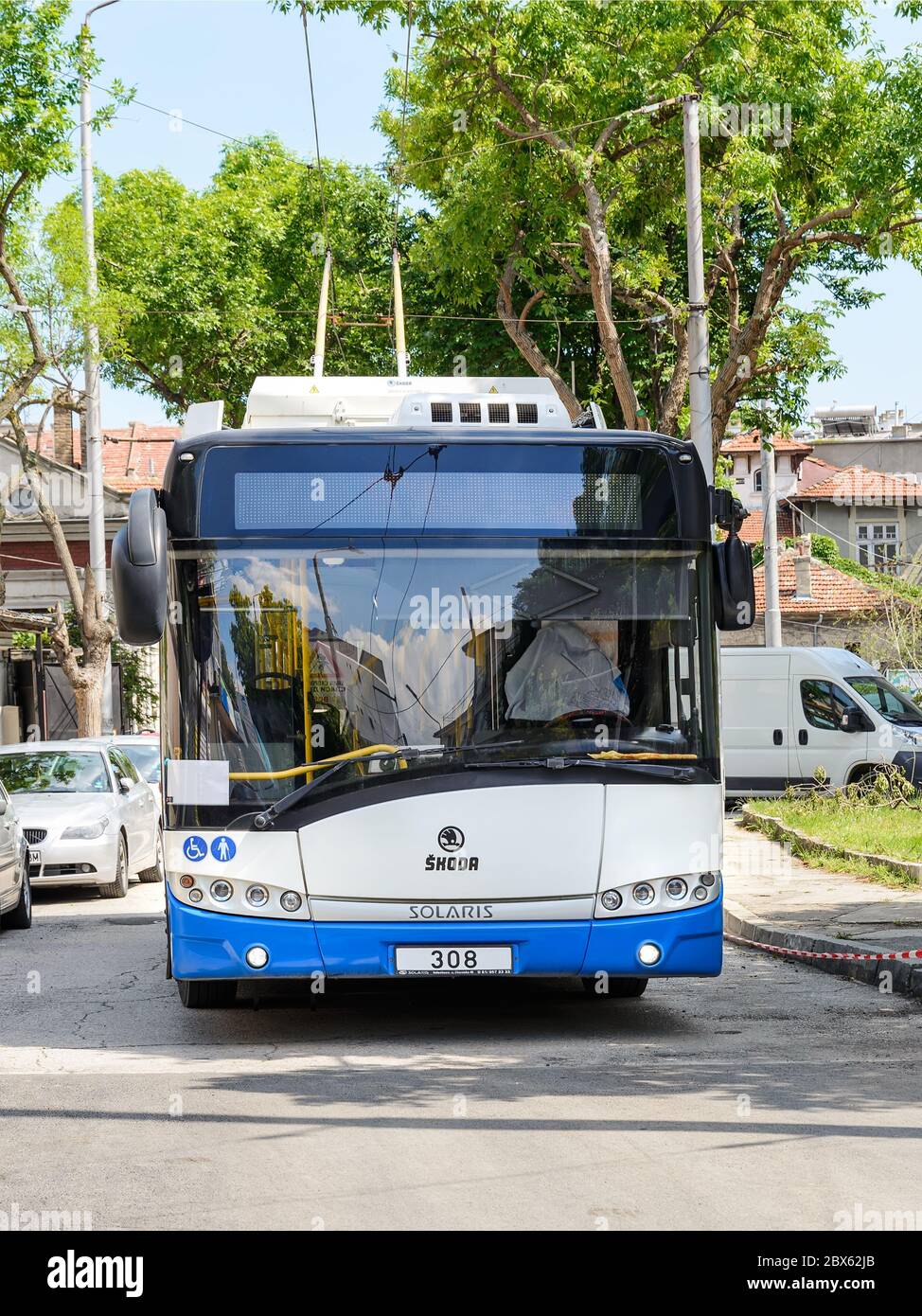 Varna, Bulgaria, June 04, 2020. White blue Skoda trolleybus based on Solaris vehicle on a city street on a sunny summer day. City electric transport. Stock Photo