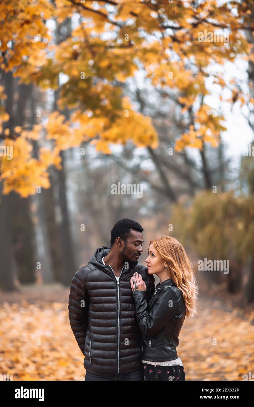 Interracial Couple Posing In Blurry Autumn Park Background Black Man And White Redhead Woman
