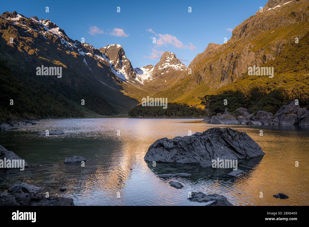 Emily peak reflecting in McKenzie lake at sunset, Routeburn track, South Island, New Zealand Stock Photo