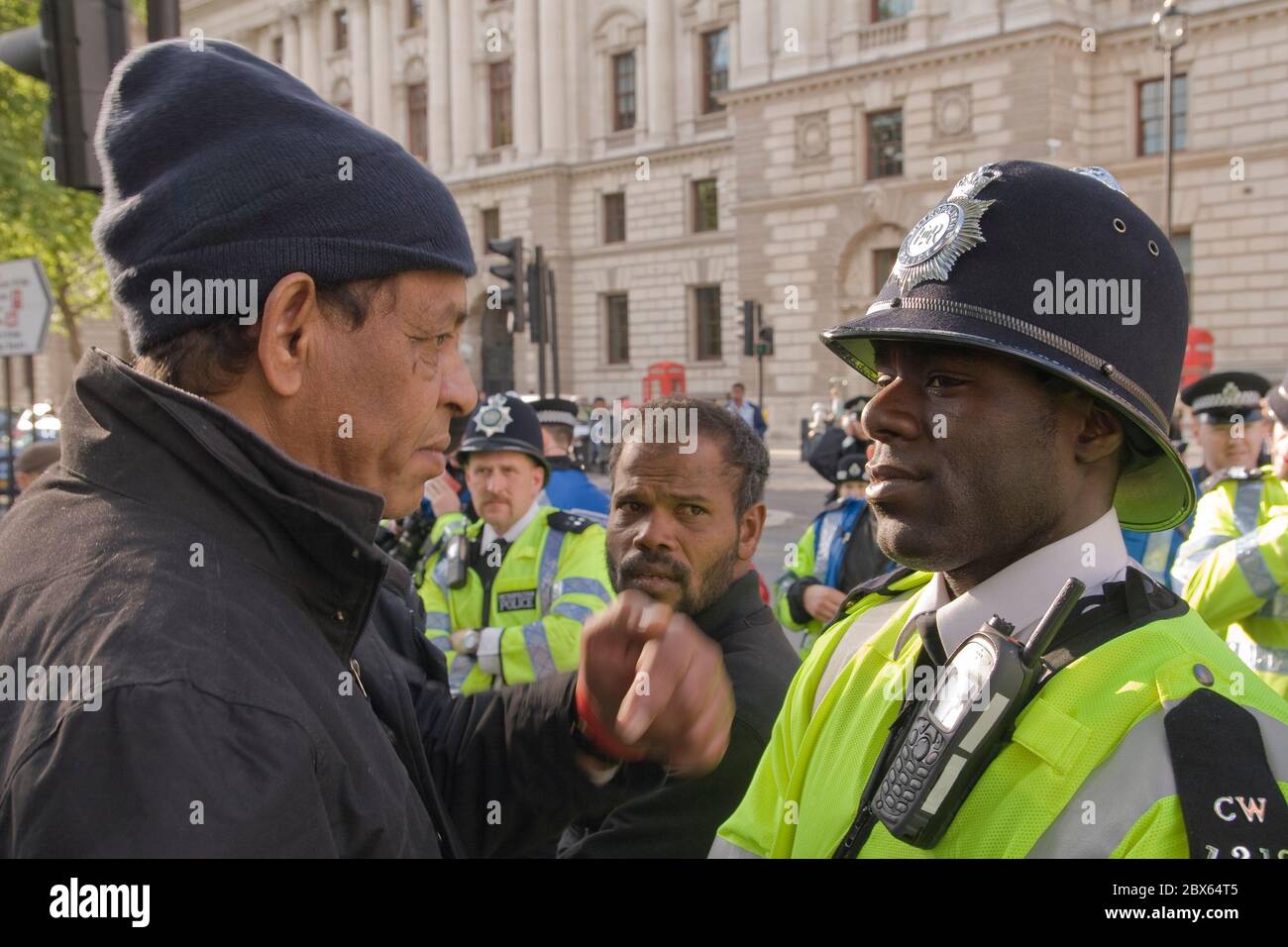 Tamil protestor confront black policeman in London during demonstration 2009 Stock Photo