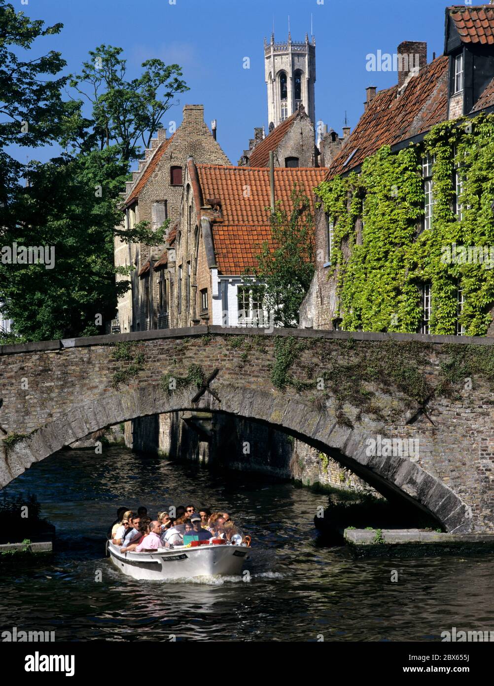 Tour boat travelling along canal in the old town Stock Photo