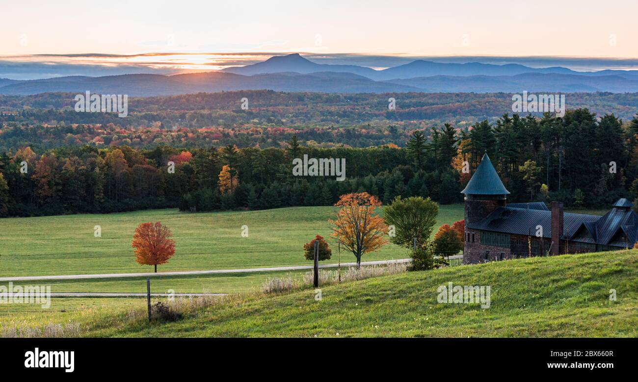 rising sun lights up  Camels Hump Mountain and the Champlain Valley  at Shelburne Farms  historic Barn Stock Photo