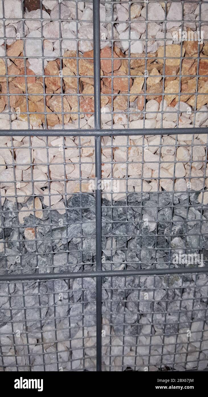 different stones in metal cage for outdoor decoration Stock Photo Alamy