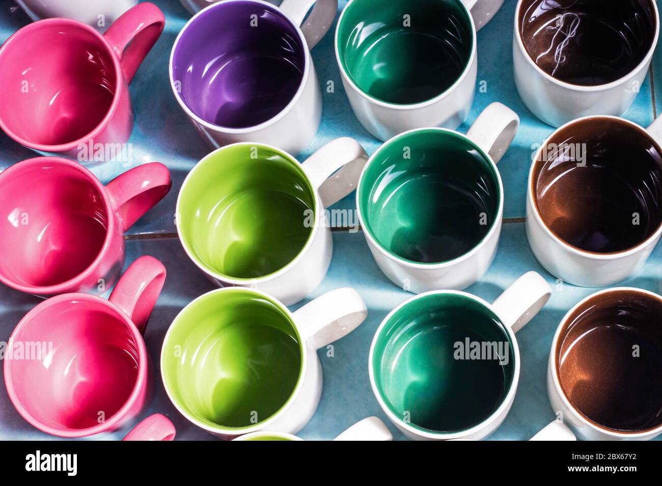 Thick glass mugs stacked. Drinking water storage containers. Light  background Stock Photo - Alamy