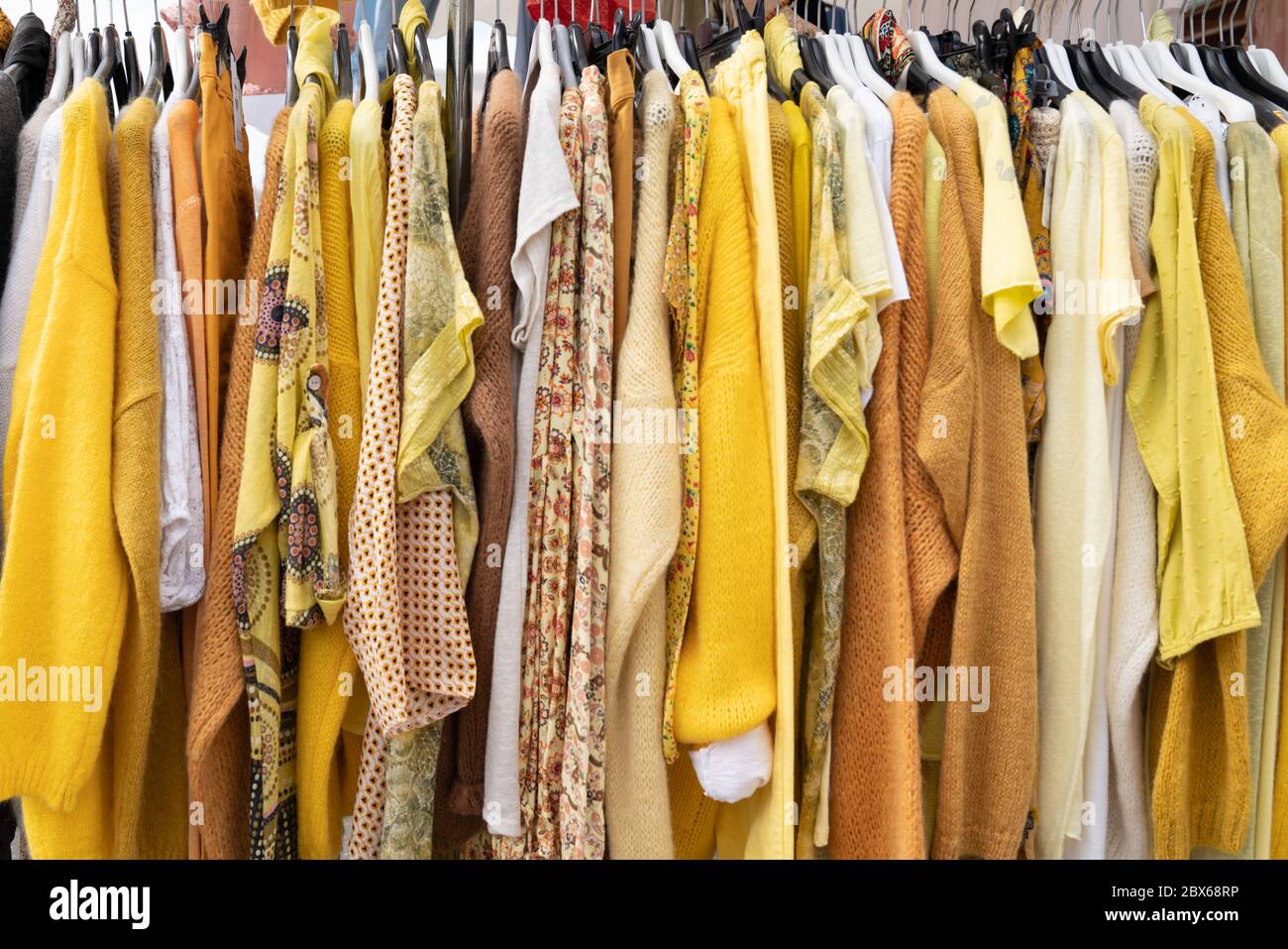 Clothes hangers with colorful clothes in a women shop. Summer sa Stock  Photo by ©Volurol 115457946