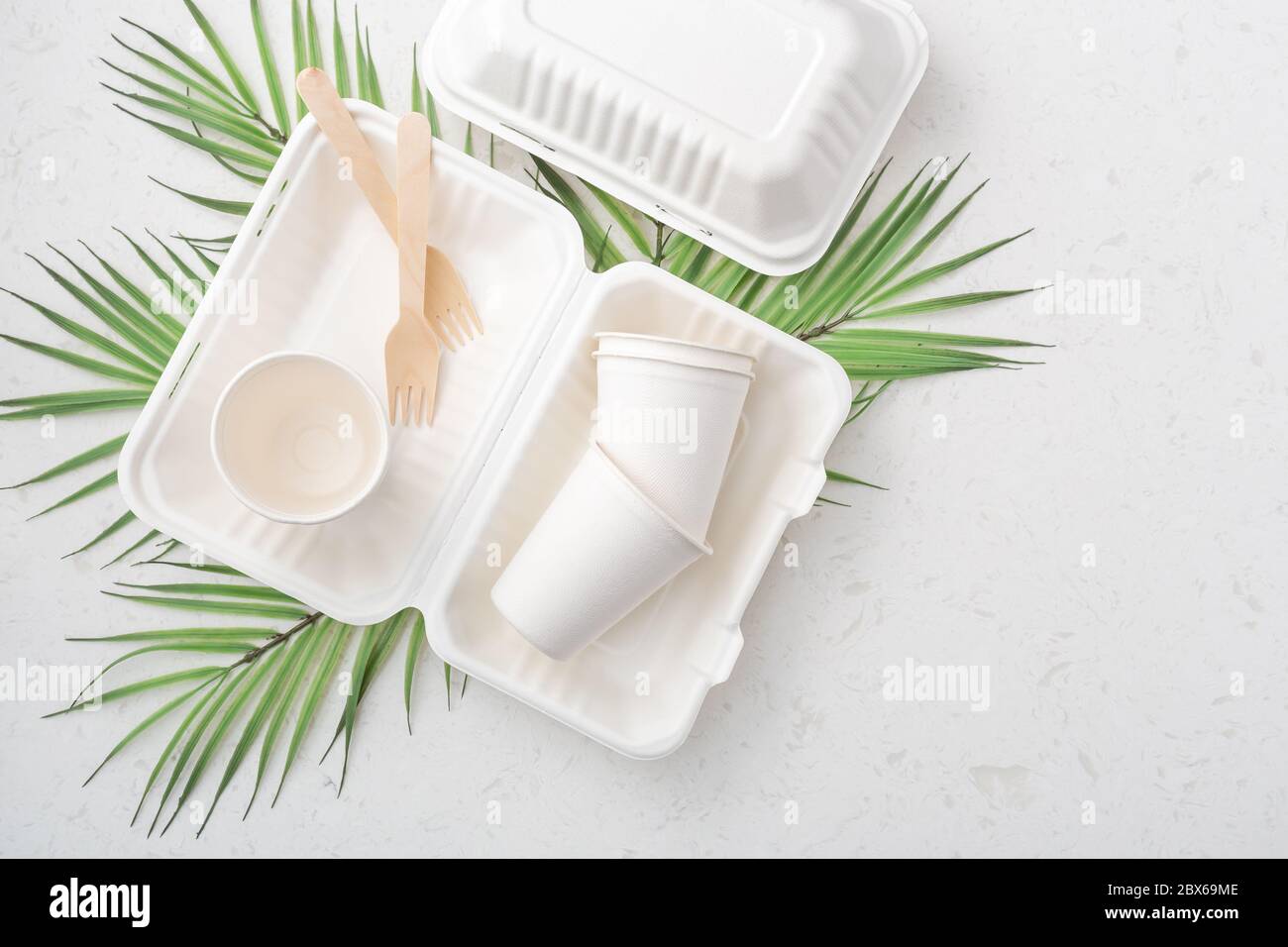 Eco friendly food packaging on white quartz background with copy space ...