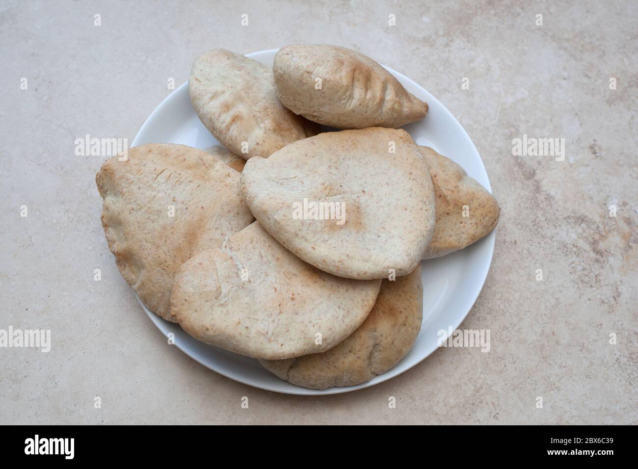 Fresh baked flat pitta breads served on a white dish Stock Photo