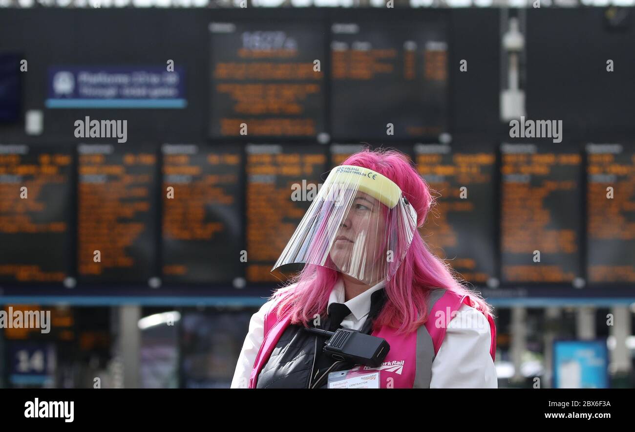 A customer service assistant at Edinburgh Waverley Station wears a protective mask as Scotland moves into phase one of the Scottish Government's plan for gradually lifting lockdown. Stock Photo