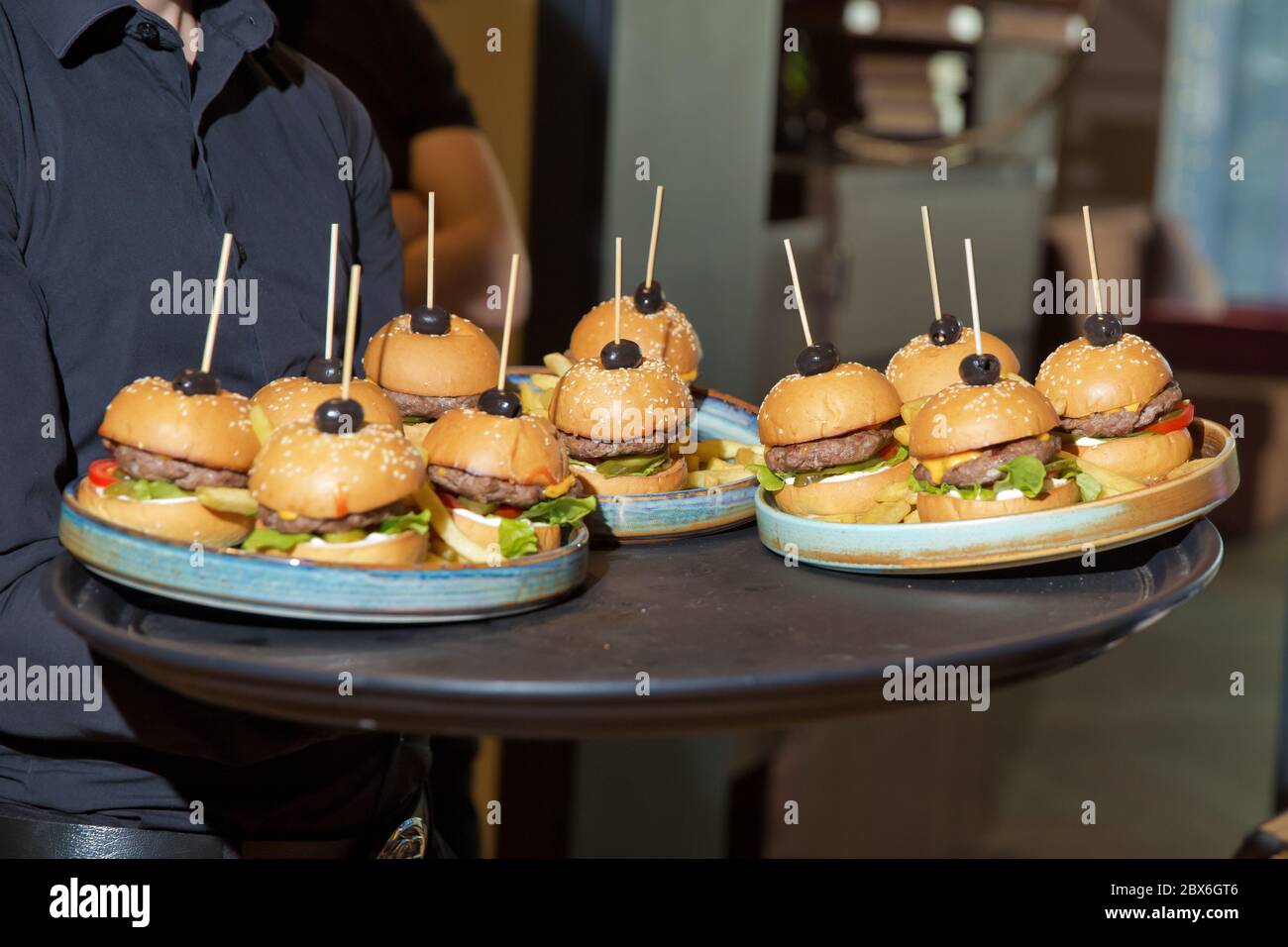 Waiter carrying a tray of appetizers. Outdoor party with finger food