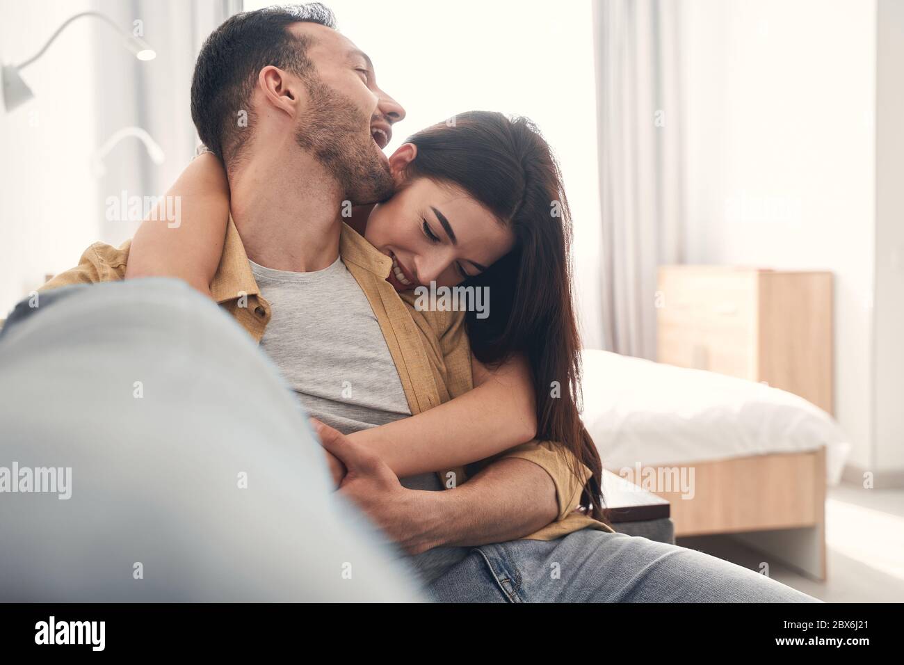 Attractive just married couple hugging at home Stock Photo
