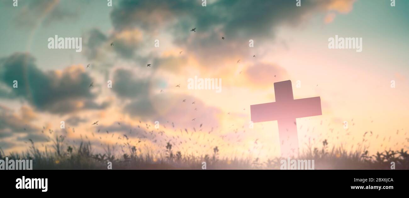 Silhouette jesus christ crucifix on cross on calvary sunset background concept for good friday he is risen in easter day, good friday jesus death on c Stock Photo