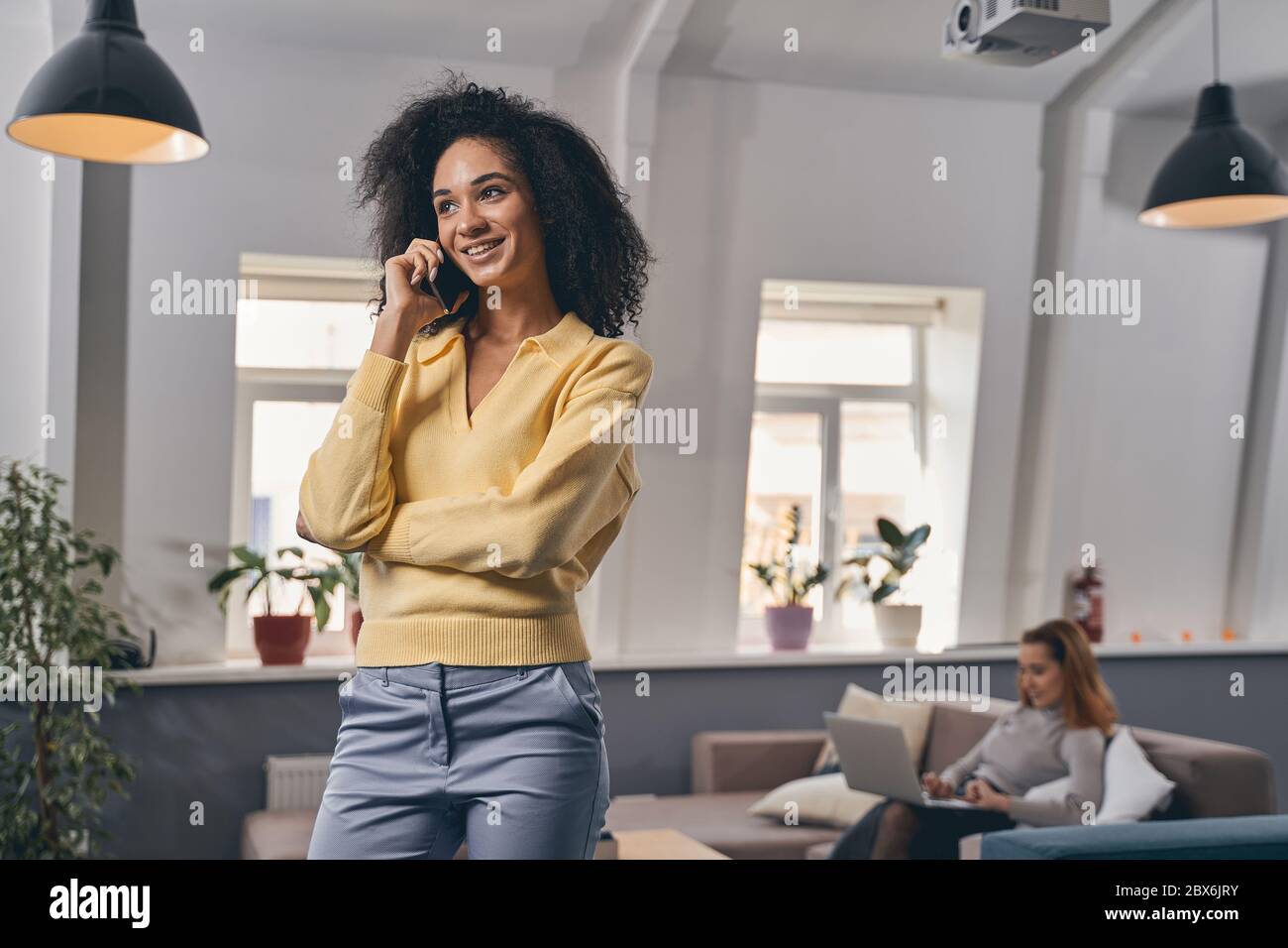 Cheerful pretty lady talking on her smartphone Stock Photo