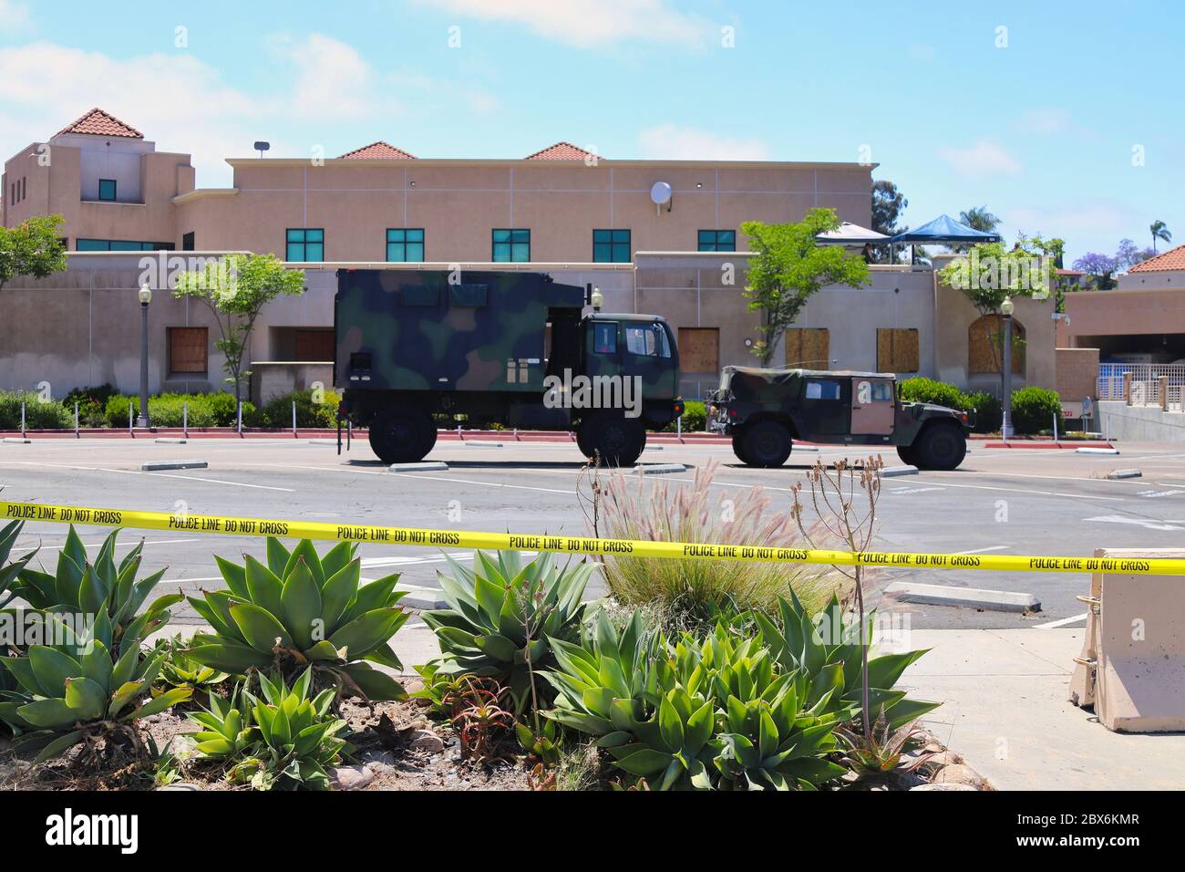 La Mesa, CA June 4, 2020  National Guard vehicles at boarded up La Mesa City Hall blocked off with yellow police tape after riots and protests Stock Photo