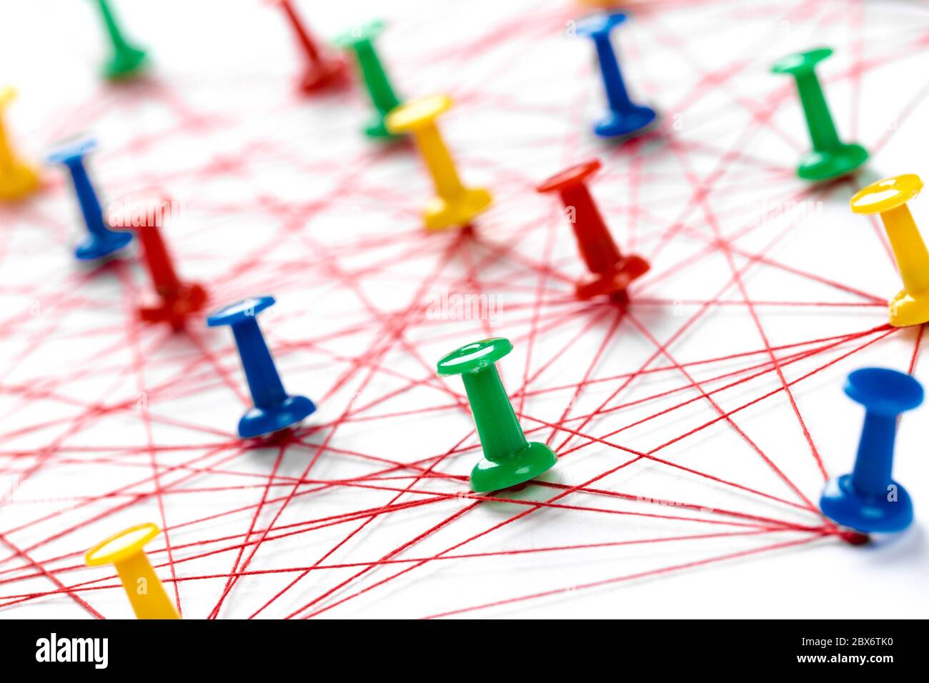 Network connection made from push pins and thread on blue background,  close-up Stock Photo - Alamy