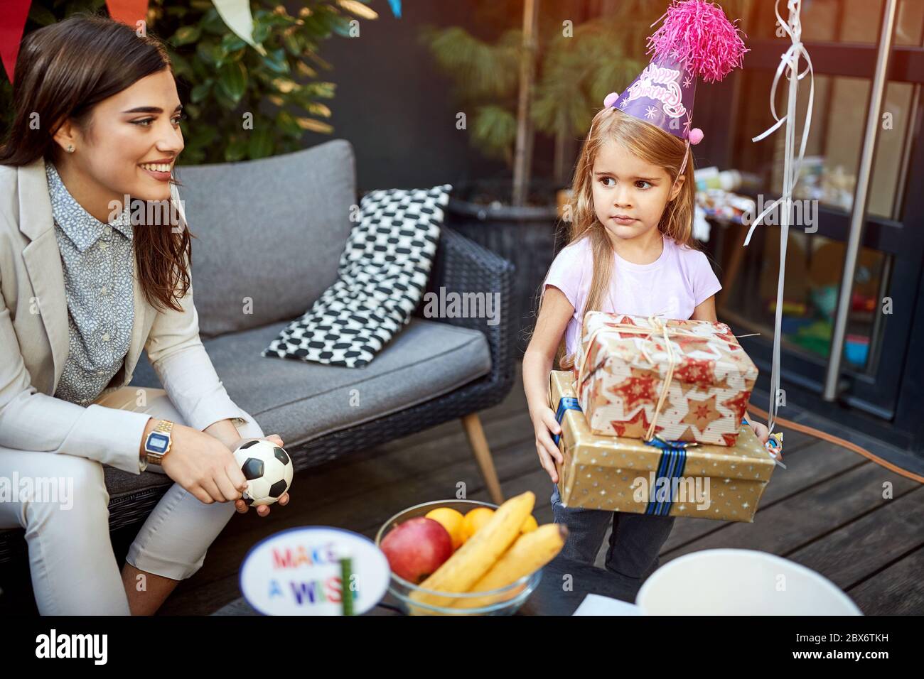 Birthday girl with gifts together with mom outdoor Stock Photo
