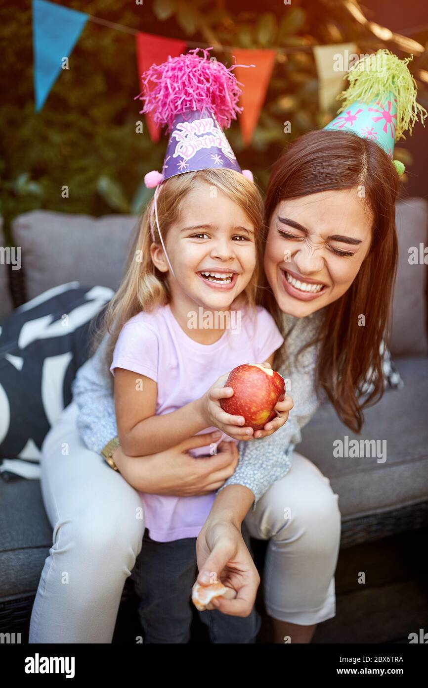 Cheerful mother child celebrating birthday of her daughter Stock Photo