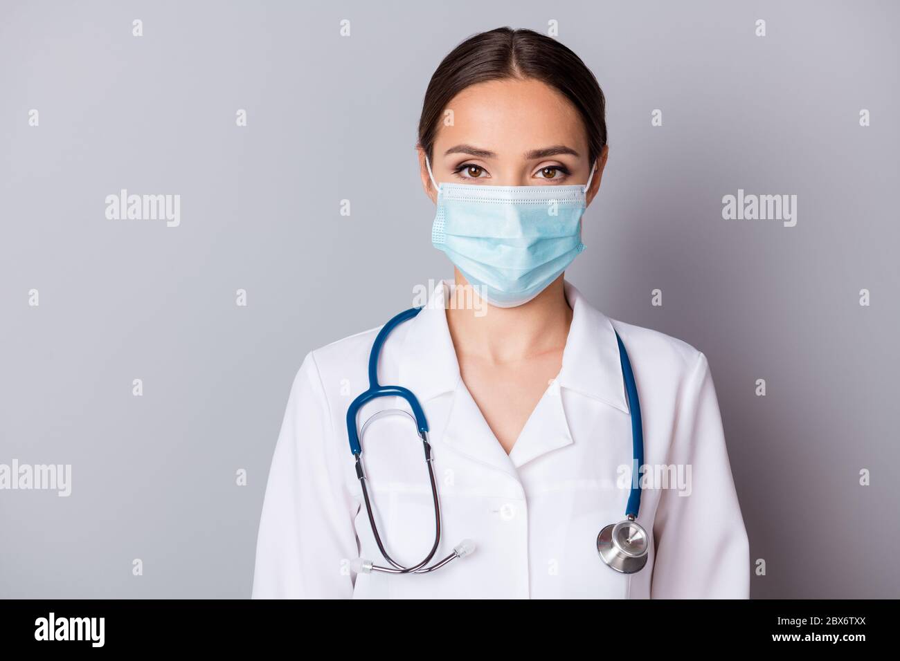 Closeup photo of attractive serious virologist doc lady experienced professional listen patient wear facial mask medical uniform lab coat stethoscope Stock Photo