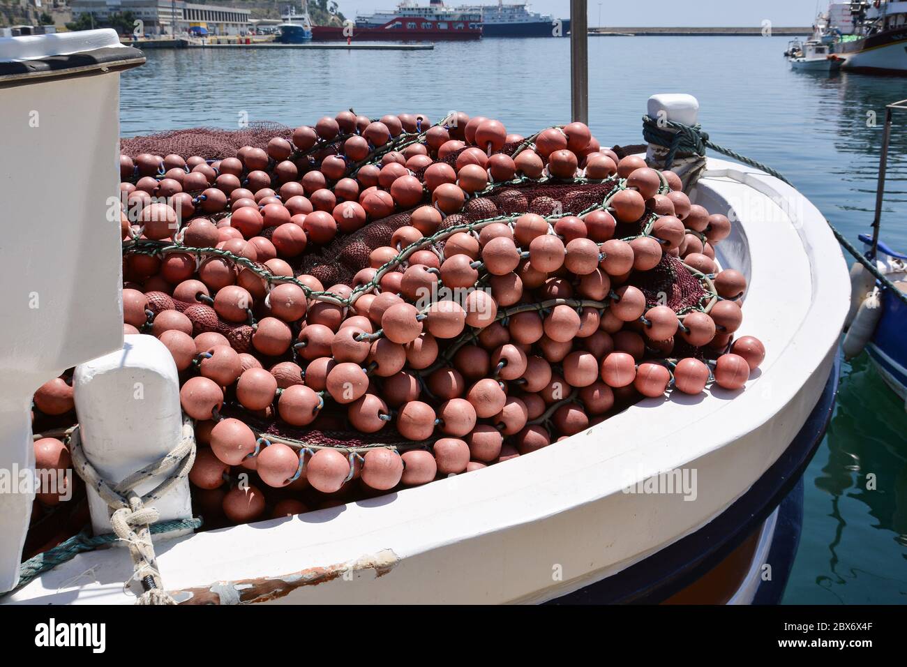 Fishing nets and buoys on board a fishing boat in the port of Kavala, Greece. Stock Photo