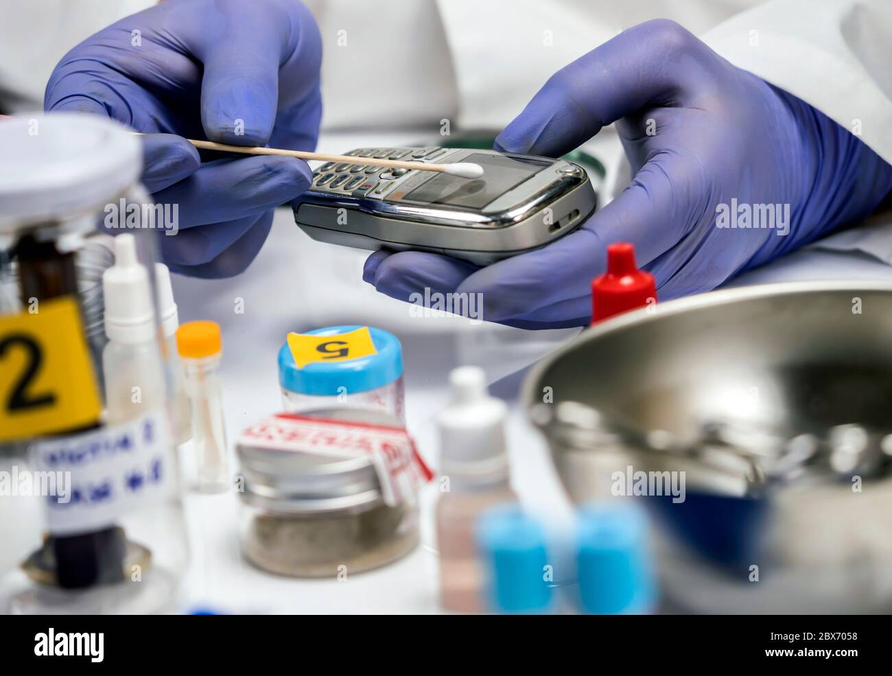 Specialist police take DNA sample from murder victim's mobile phone, conceptual image Stock Photo
