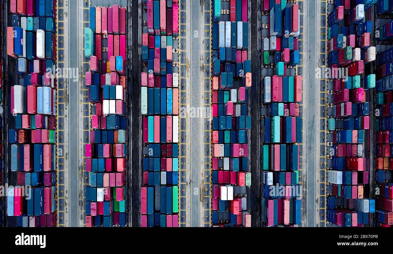 Top view on the colorful containers pilled up in the container terminal/port creating an abstractive pattern Stock Photo