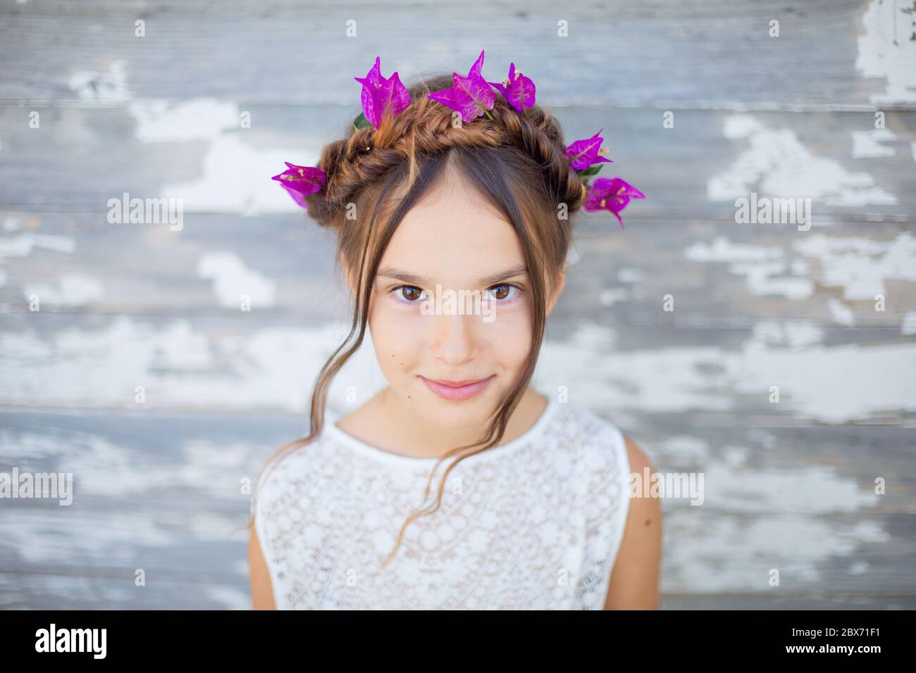 Portrait beautiful young girl with flower wreath on her head on old ...