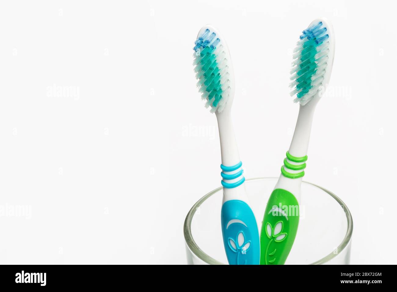 Set of colorful toothbrushes in glass on white background Stock Photo ...